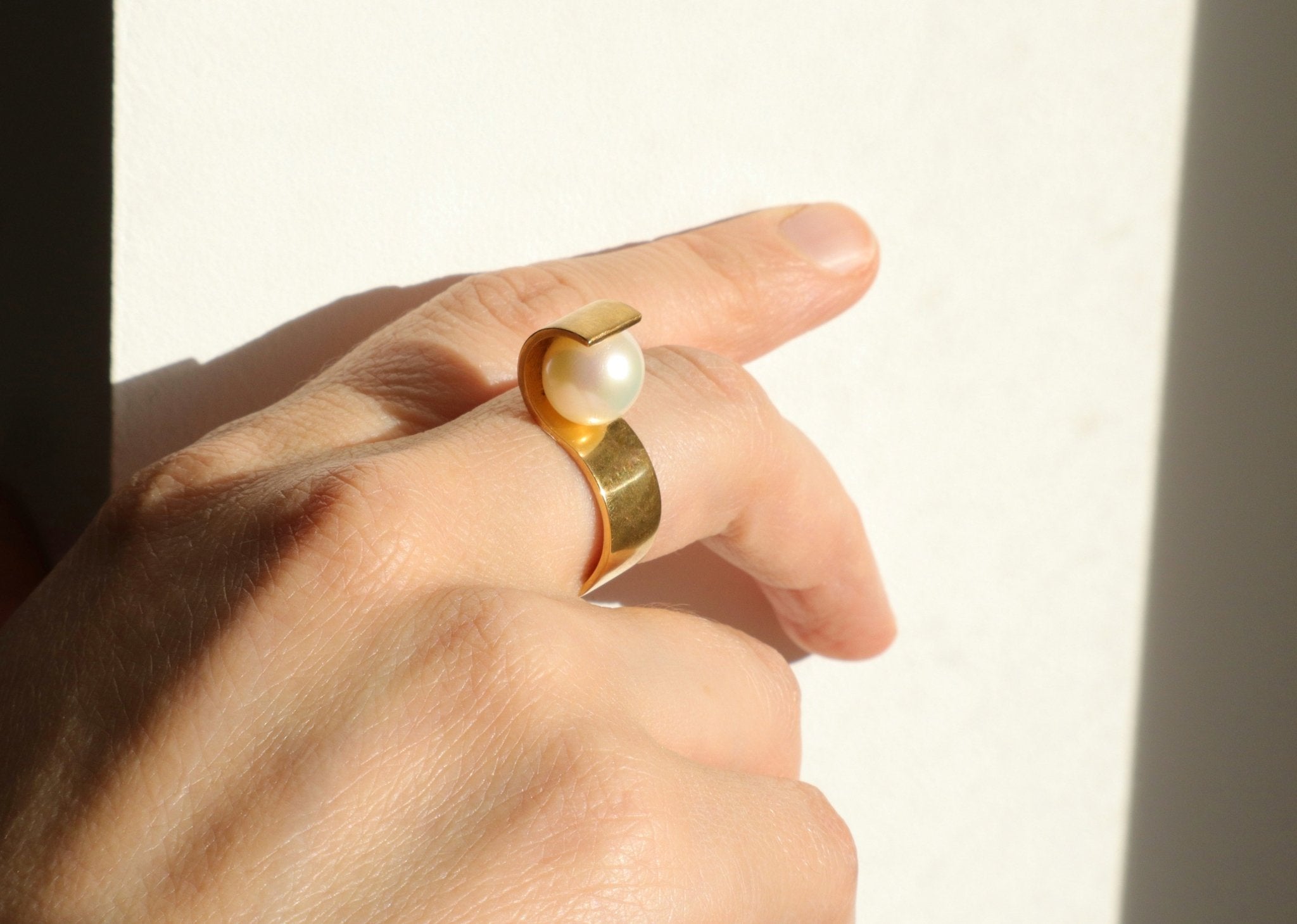Bague S portée sur la main, illustrant le style art deco de ce bijou de créateur contemporain.